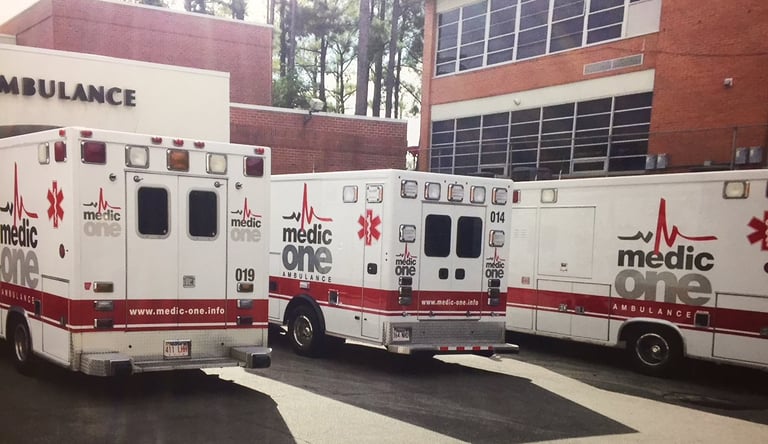 three medic one ambulance cars parking in front of hospital