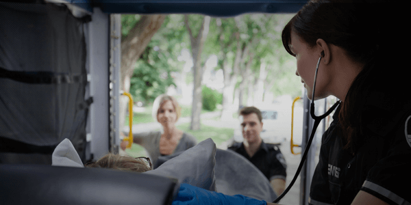 Paramedic with patient in ambulance