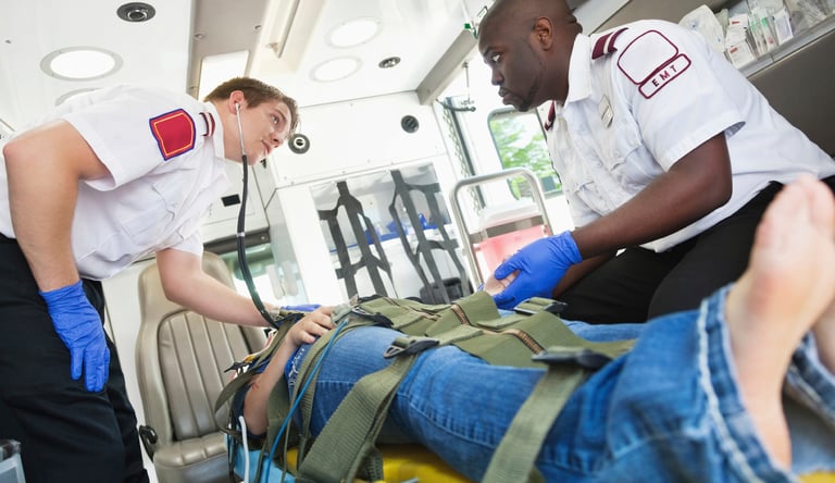 two men diagnosing a patient on the ambulance