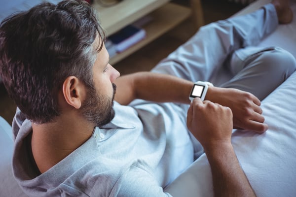 Father using a smart watch at home