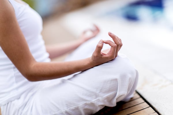 Yoga woman meditating and making a zen symbol with her hand