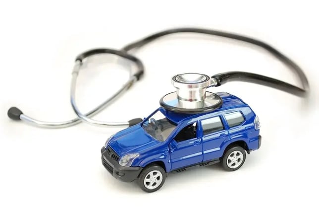 A blue toy car with a stethoscope bell touching to the top of the car.