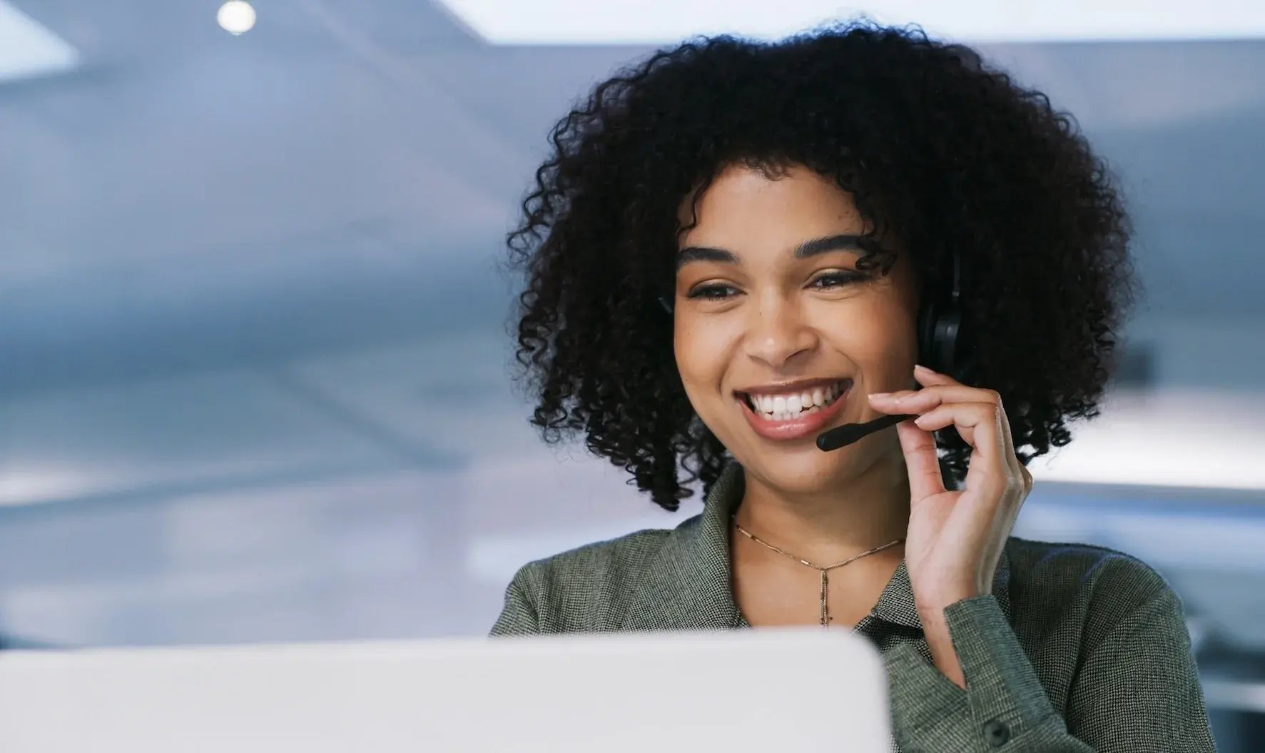 Woman taking a call on a headset. 