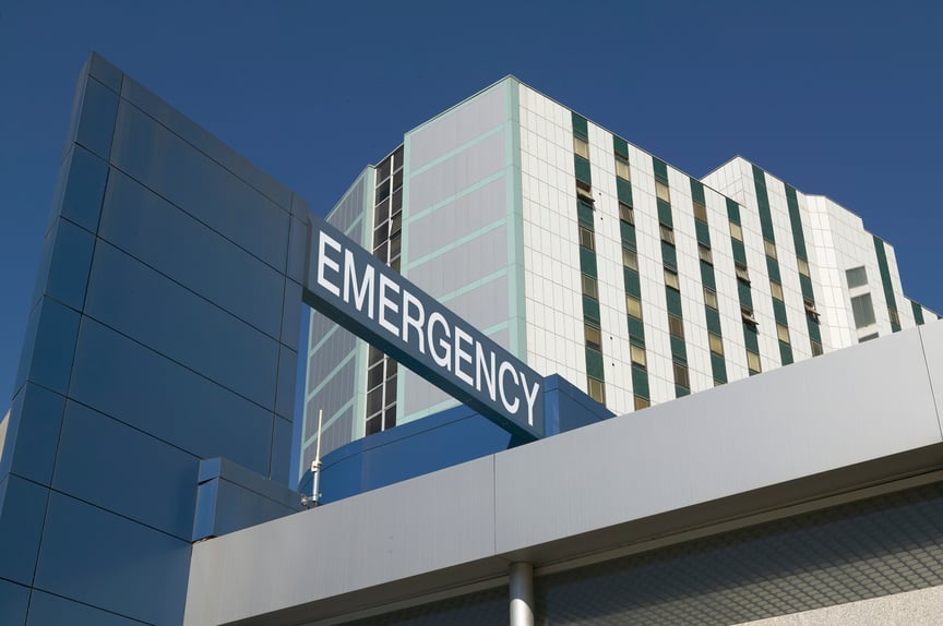 Exterior of hospital with an "Emergency" sign