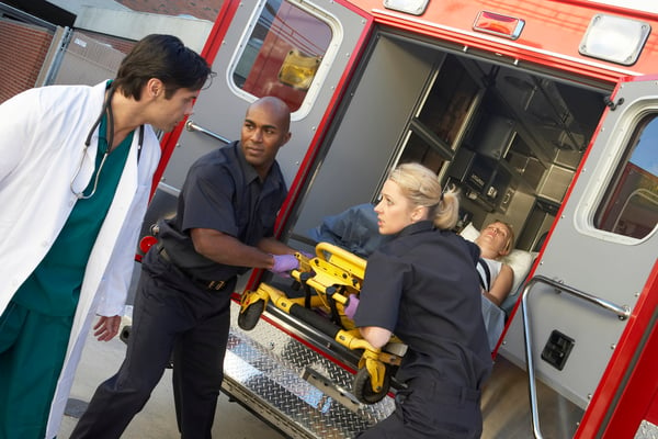 Paramedics communicating with doctor